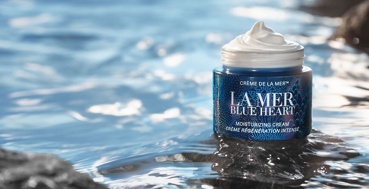 A limited edition blue heart pot in the sea on a rock